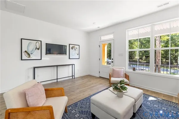 a living room with furniture and painting on the wall