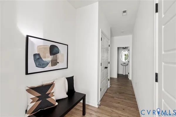 a view of a hallway with wooden floor
