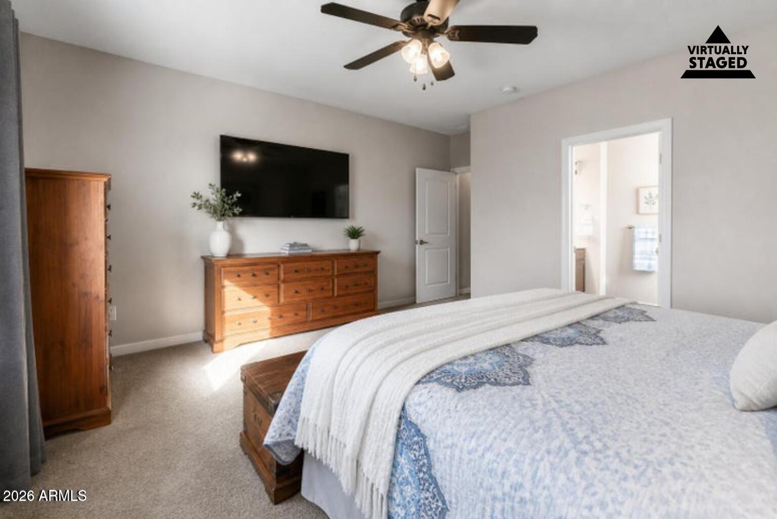 614 North Tomahawk Road Apache Junction, AZ 85119 - Photo 14 of 44 a bedroom with a bed and a flat screen tv