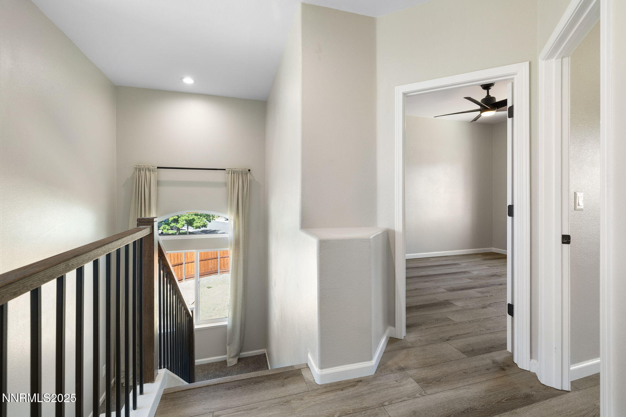 7510 Michaela Drive Reno, NV 89511 - Photo 12 of 33 a view of a hallway with wooden floor and a bathroom