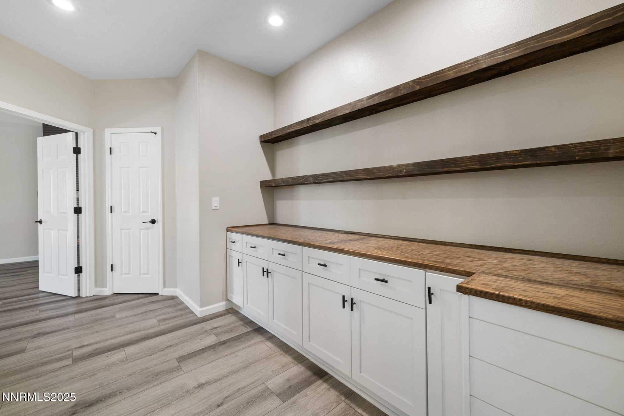 7510 Michaela Drive Reno, NV 89511 - Photo 14 of 33 a kitchen with granite countertop white cabinets and a wooden floor