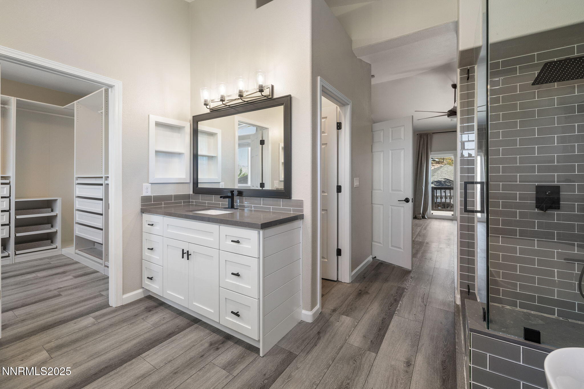 7510 Michaela Drive Reno, NV 89511 - Photo 17 of 33 a bathroom with a granite countertop sink a mirror and shower