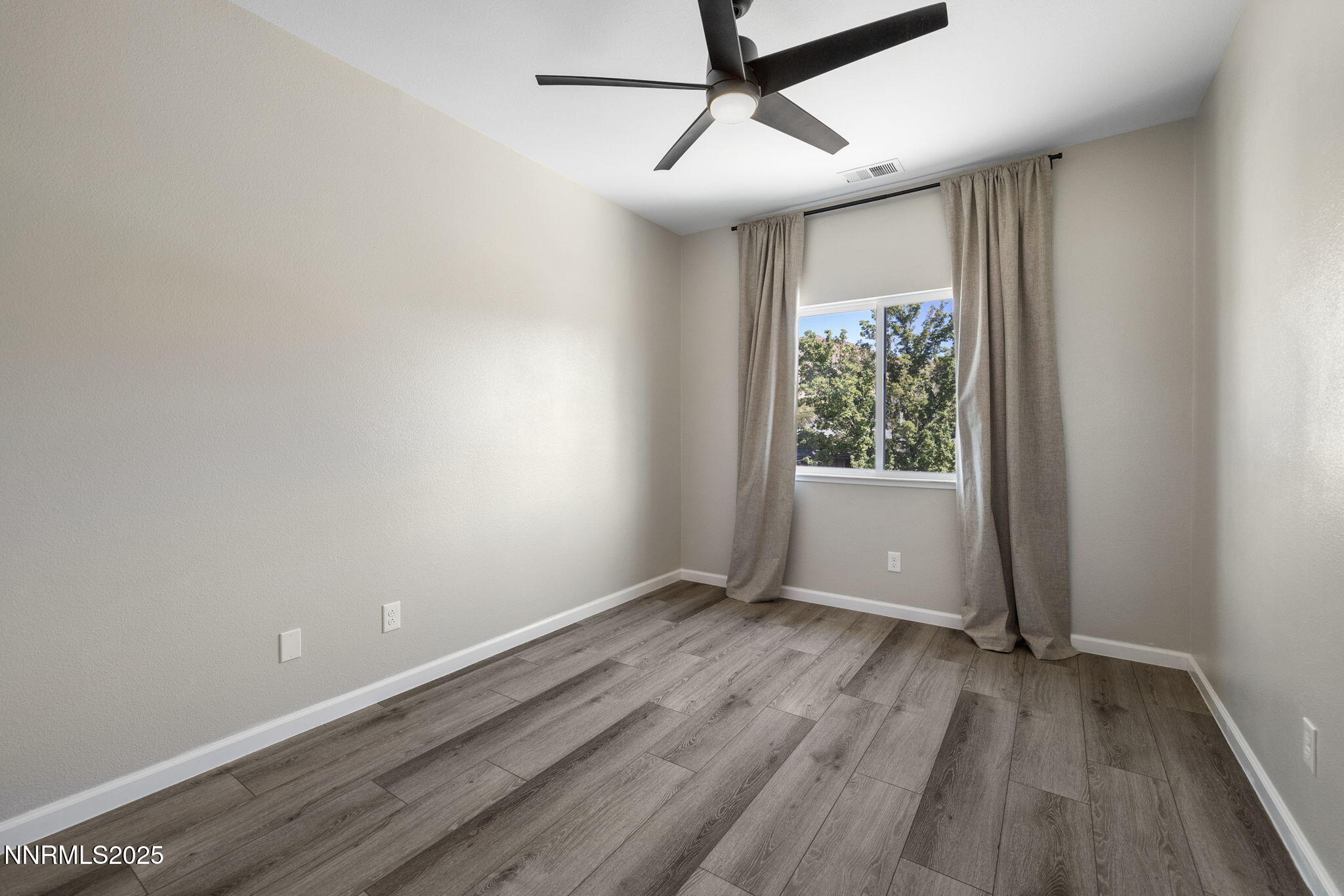 7510 Michaela Drive Reno, NV 89511 - Photo 21 of 33 a view of room with window ceiling fan and hardwood floor