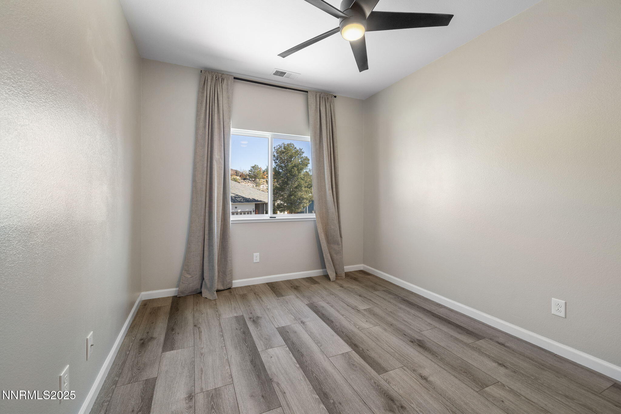 7510 Michaela Drive Reno, NV 89511 - Photo 22 of 33 wooden floor in an empty room with a window