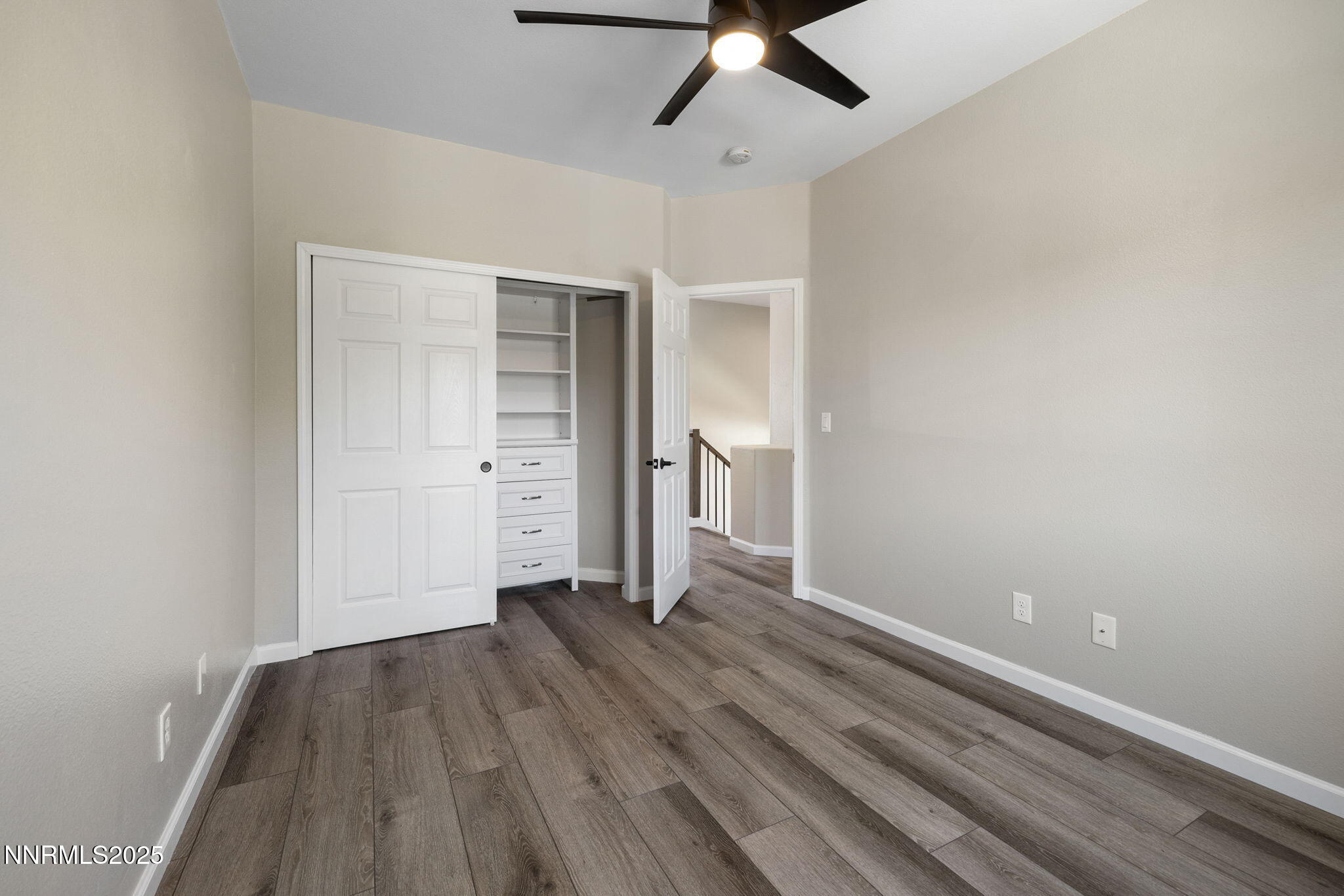 7510 Michaela Drive Reno, NV 89511 - Photo 23 of 33 an empty room with wooden floor cabinet and windows