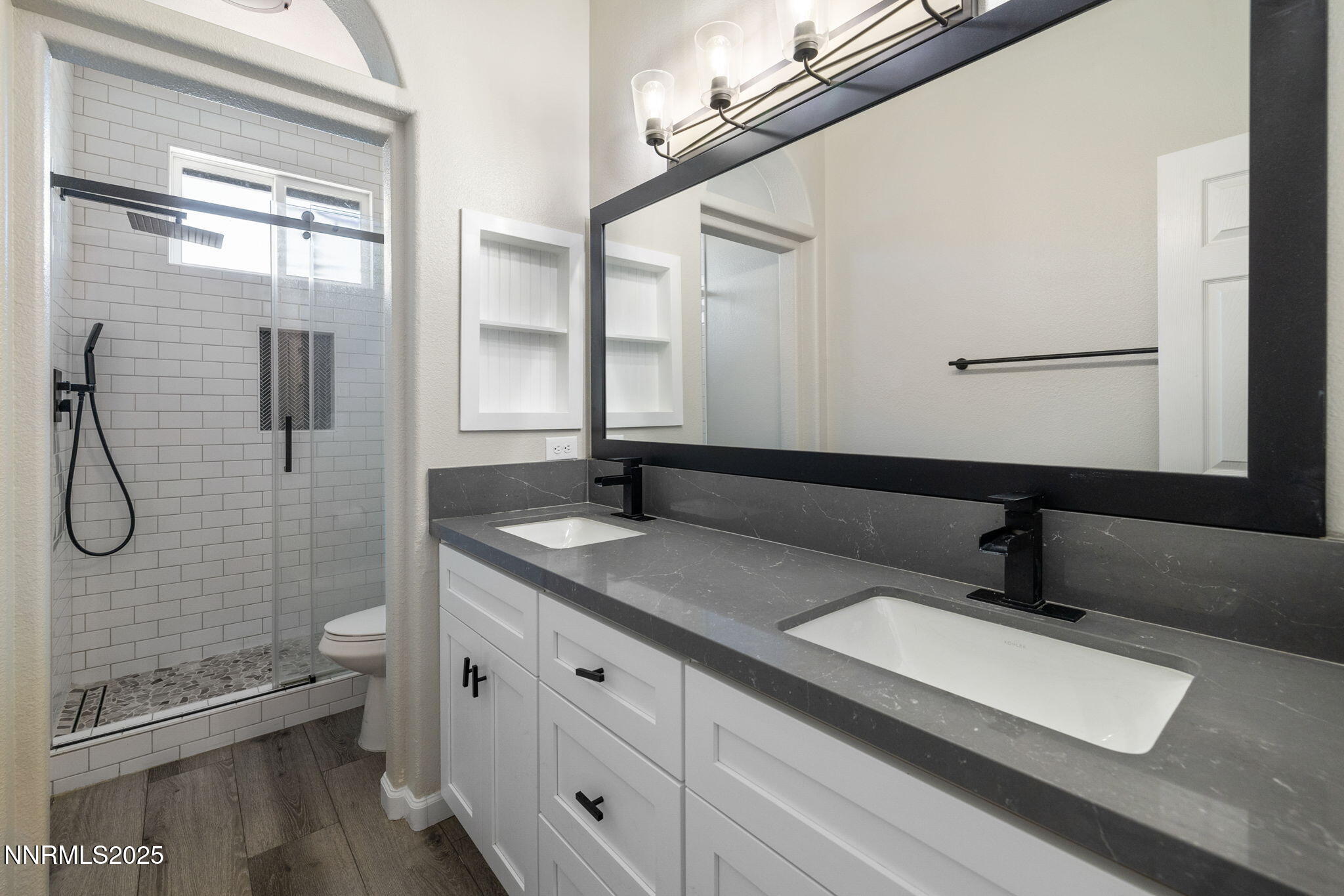 7510 Michaela Drive Reno, NV 89511 - Photo 25 of 33 a bathroom with a granite countertop sink a toilet and a mirror