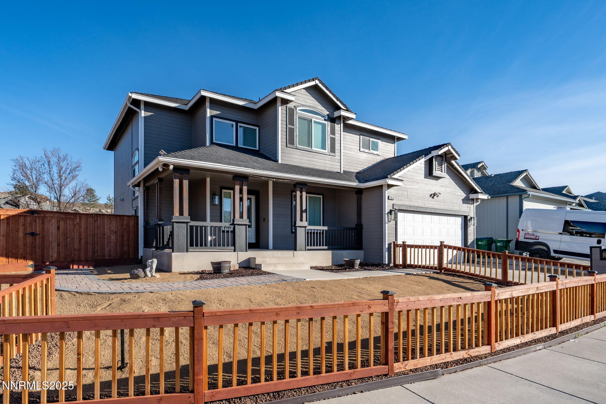 7510 Michaela Drive Reno, NV 89511 - Photo 27 of 33 a view of a white house with a small yard and wooden fence