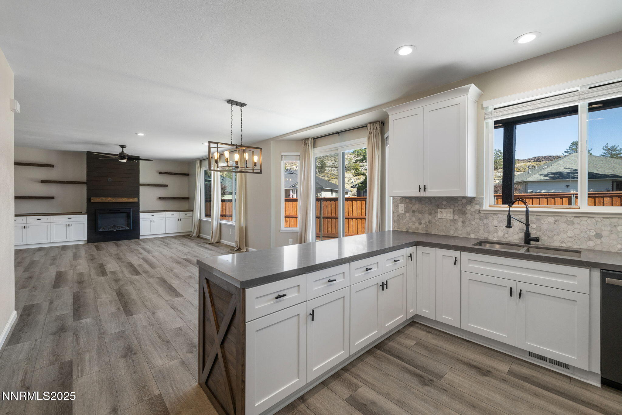 7510 Michaela Drive Reno, NV 89511 - Photo 7 of 33 a kitchen with stainless steel appliances granite countertop a sink cabinets and wooden floor