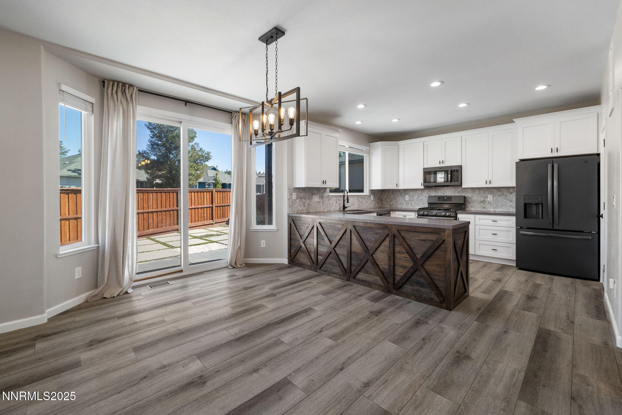 7510 Michaela Drive Reno, NV 89511 - Photo 8 of 33 a kitchen with stainless steel appliances granite countertop a refrigerator a oven a sink and a wooden floors