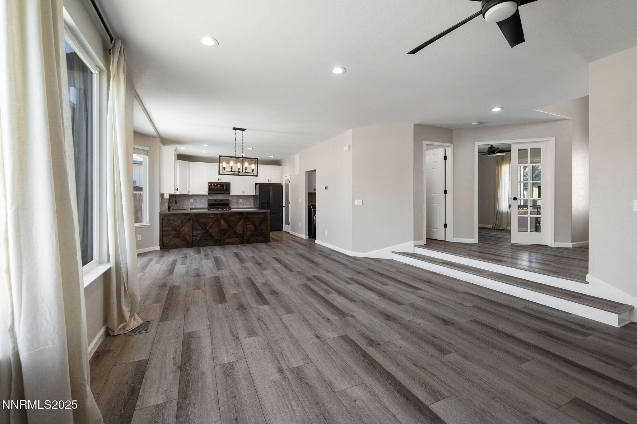 7510 Michaela Drive Reno, NV 89511 - Photo 9 of 33 an empty room with wooden floor and windows