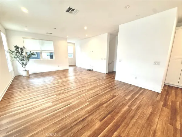 a view of a living room with wooden floor