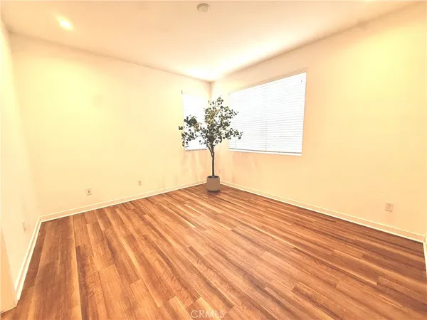 a view of a room with wooden floor and a window