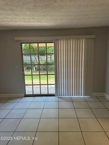 a view of a livingroom with a floor to ceiling window and a projector