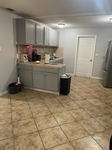 a kitchen with a sink a stove cabinets and utility room