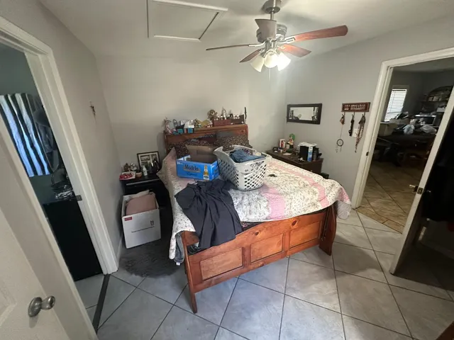 a view of a dining room with furniture and a chandelier fan