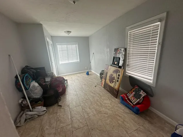 a bedroom with furniture and a window