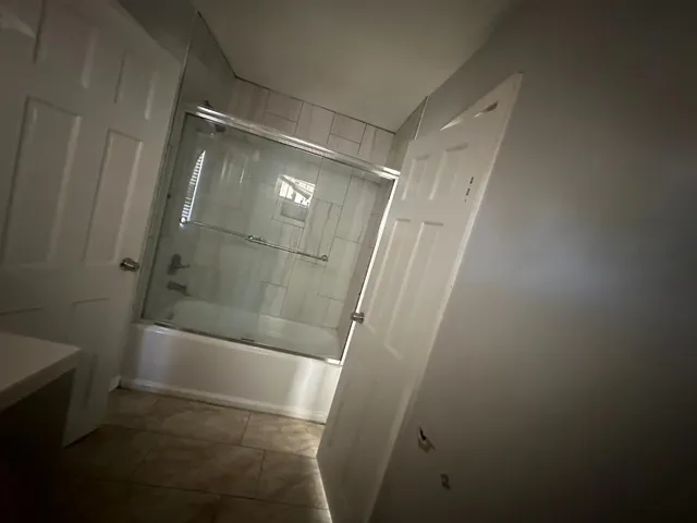 a bathroom with a glass door shower