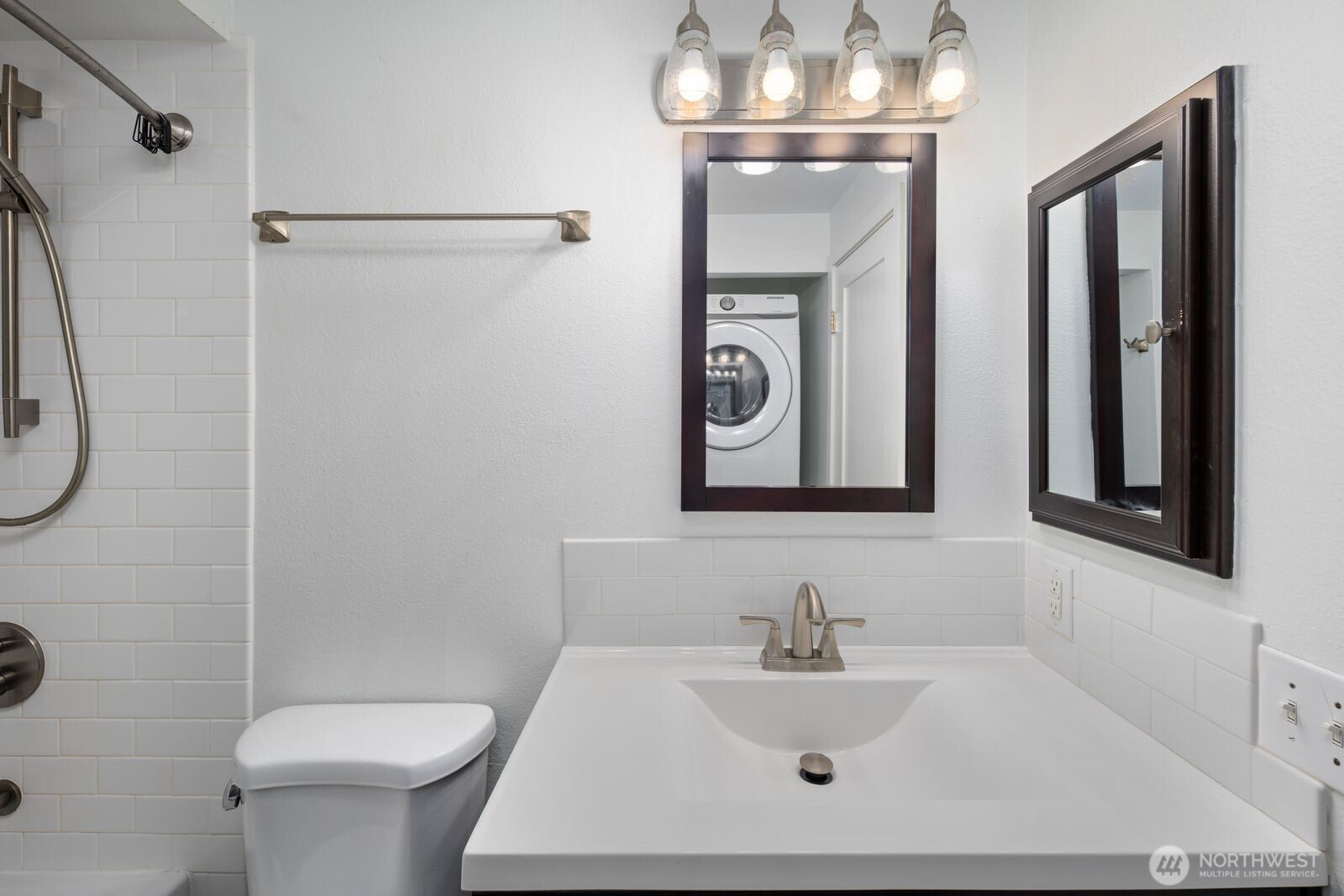 3901 Fremont Avenue North, Unit 202 Seattle, WA 98103 - Photo 14 of 23 a bathroom with a sink a toilet and a mirror
