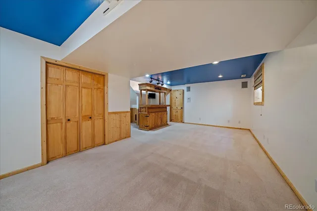 an empty room with windows and closet