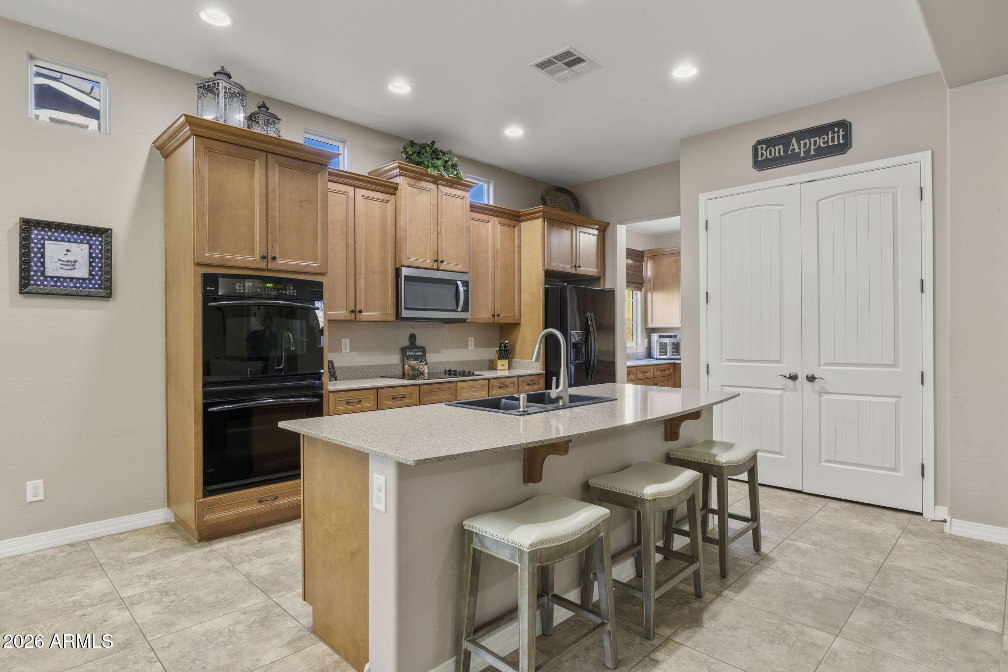 3831 East Weather Vane Road Gilbert, AZ 85296 - Photo 17 of 64 a kitchen with kitchen island a sink stove and refrigerator