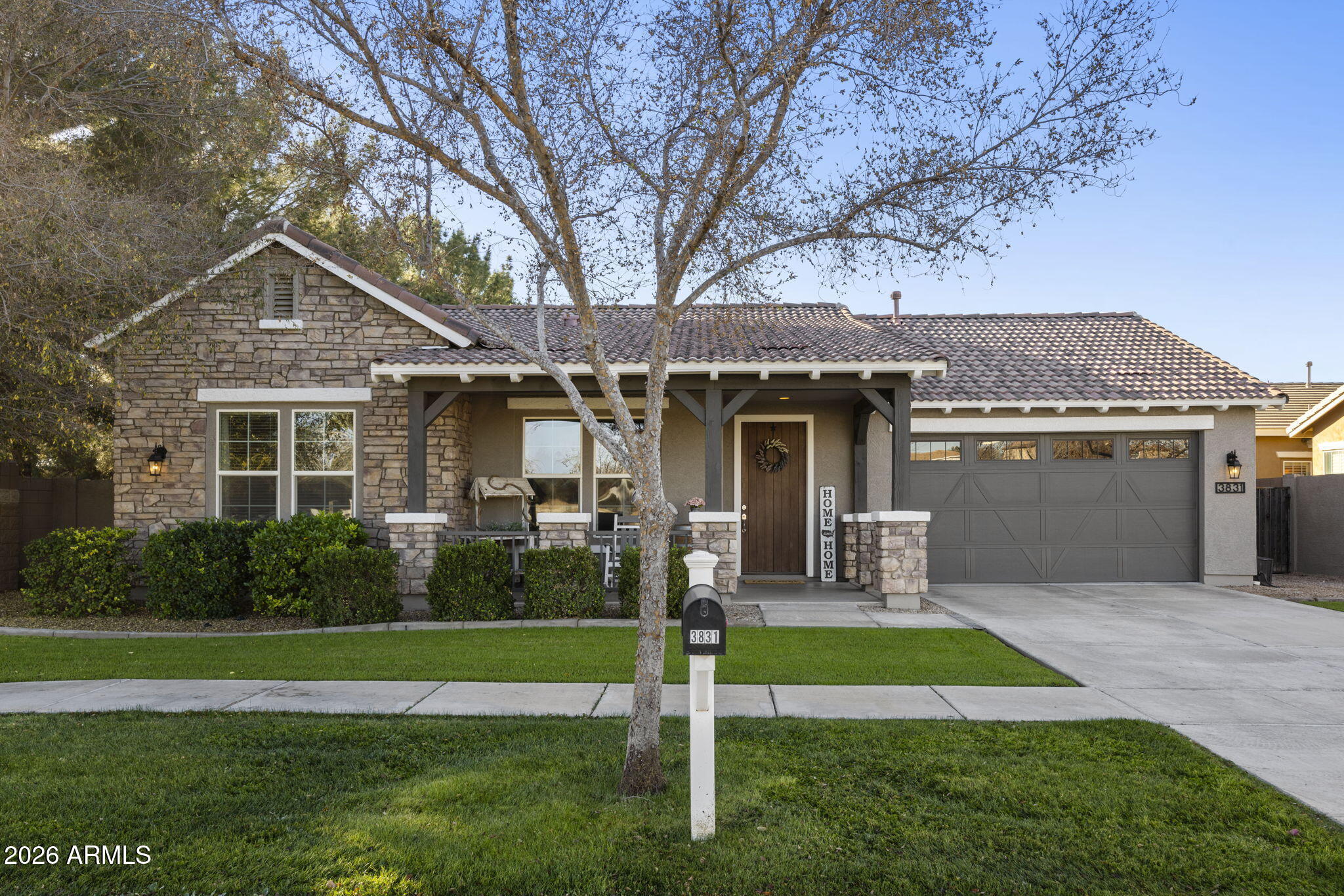3831 East Weather Vane Road Gilbert, AZ 85296 - Photo 2 of 64 a front view of a house with a yard and garage