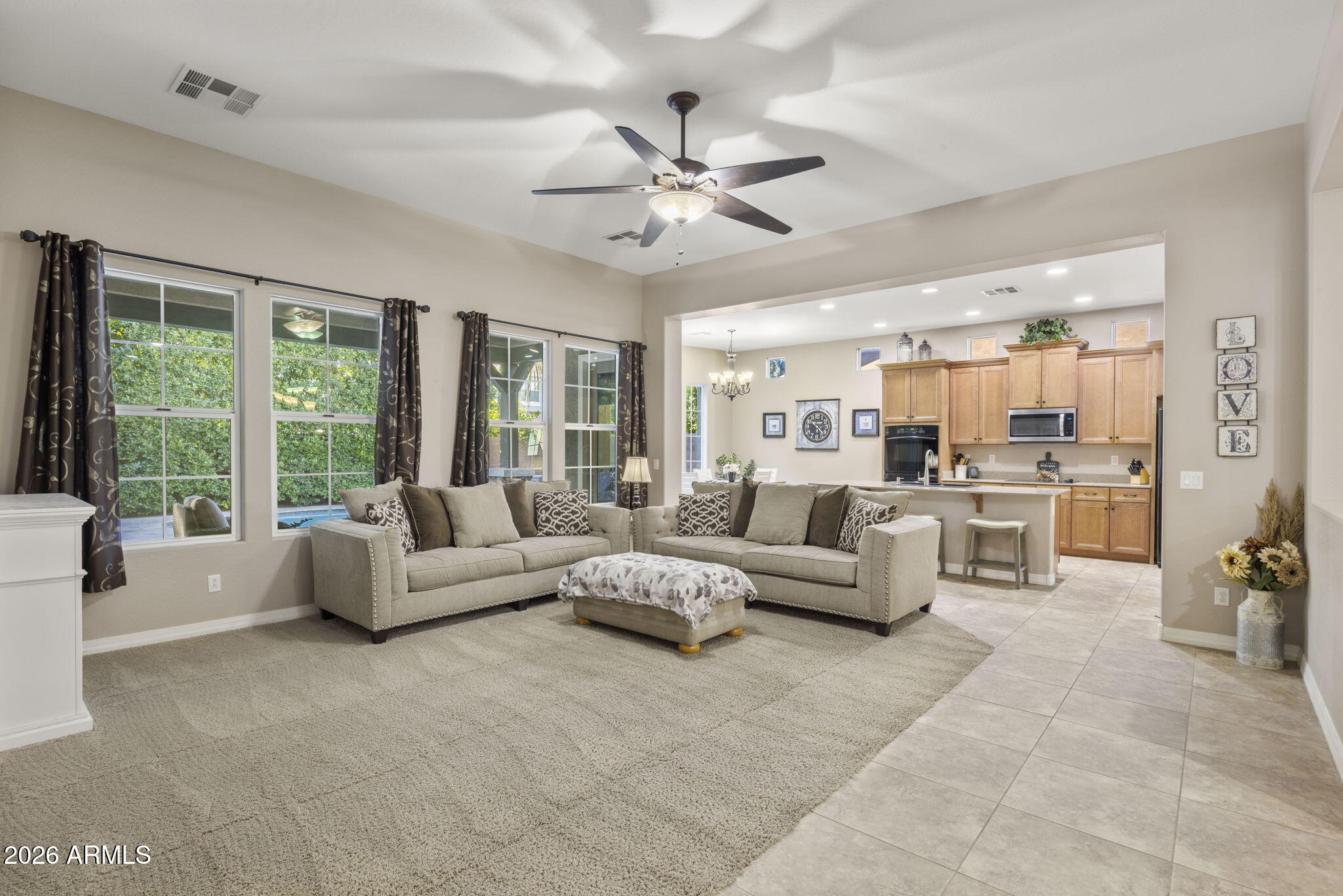 3831 East Weather Vane Road Gilbert, AZ 85296 - Photo 25 of 64 a living room with furniture and a large window with kitchen view