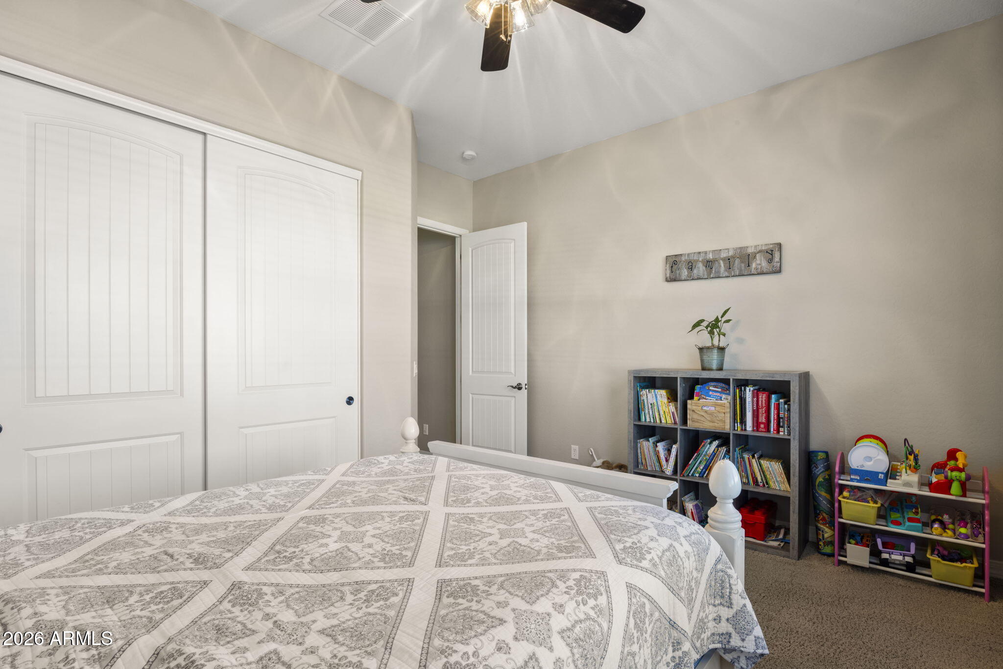 3831 East Weather Vane Road Gilbert, AZ 85296 - Photo 37 of 64 a bedroom with a bed and a book shelf