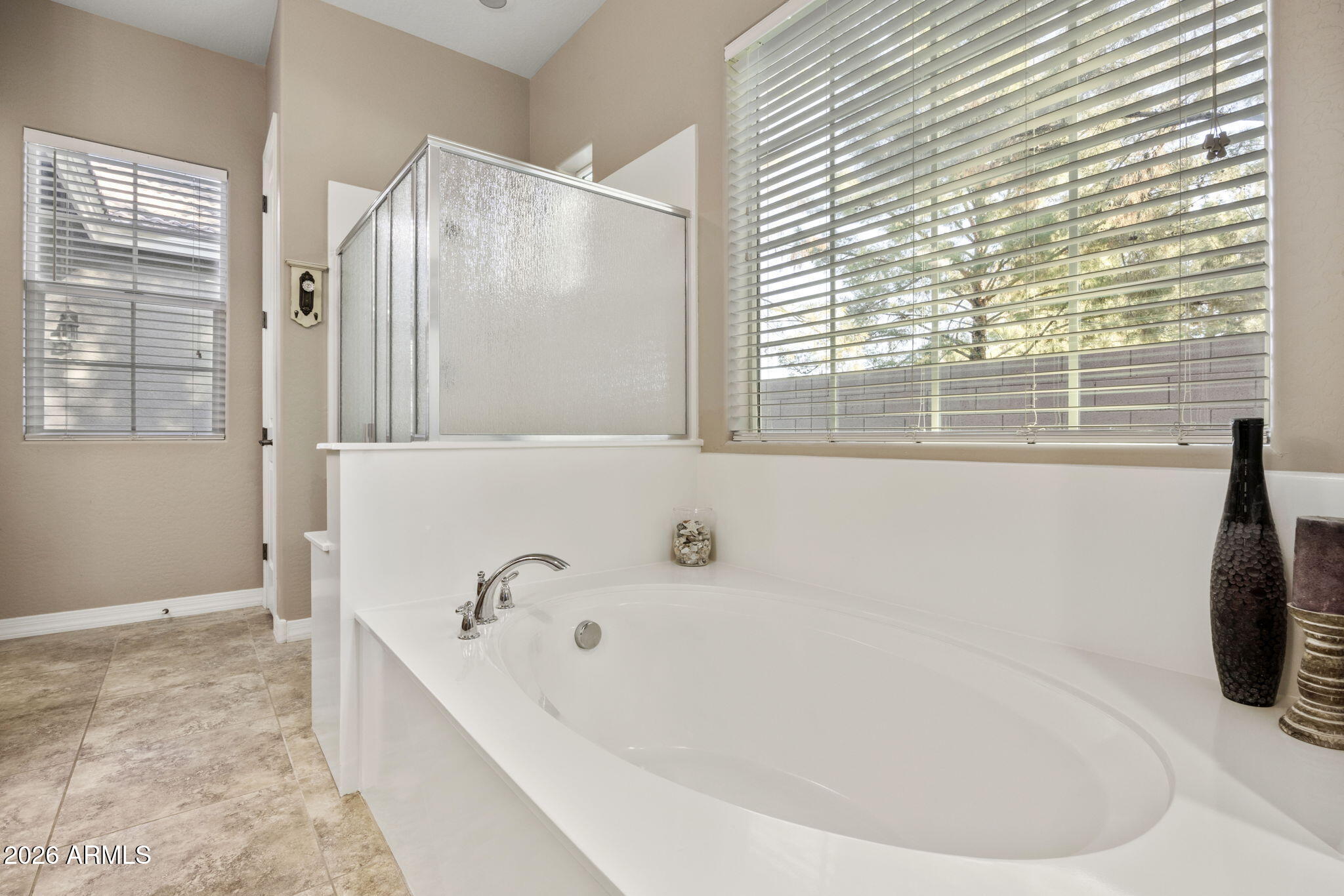 3831 East Weather Vane Road Gilbert, AZ 85296 - Photo 47 of 64 a white bath tub sitting in a bathroom next to a window