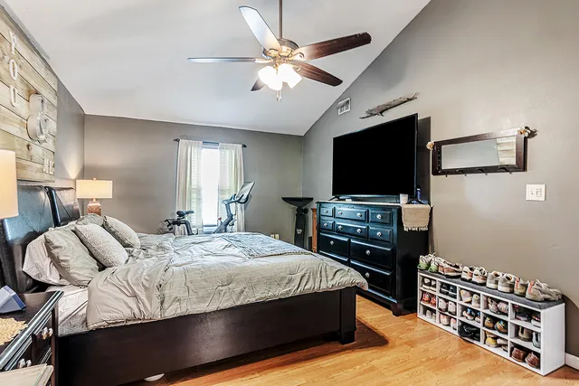 a bedroom with a bed and a flat screen tv