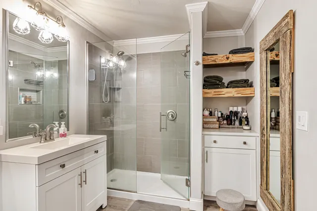 a bathroom with a shower sink and mirror