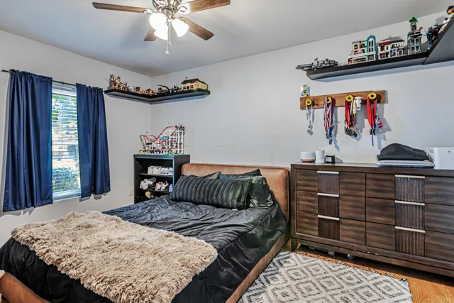 a bedroom with a bed and a chandelier