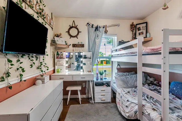 a room with furniture a flat screen tv and a fireplace