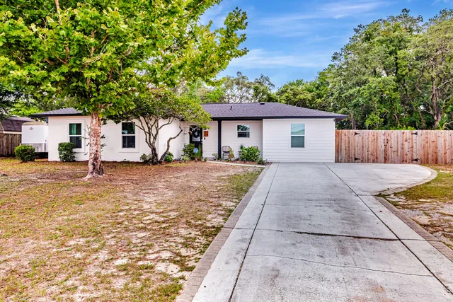 a backyard of a house with table and chairs