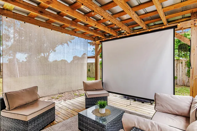 a outdoor living space with furniture and a rug