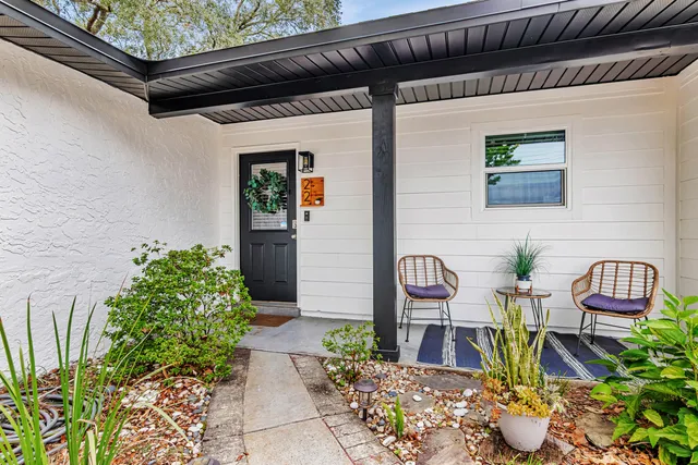 a front view of a house with outdoor seating