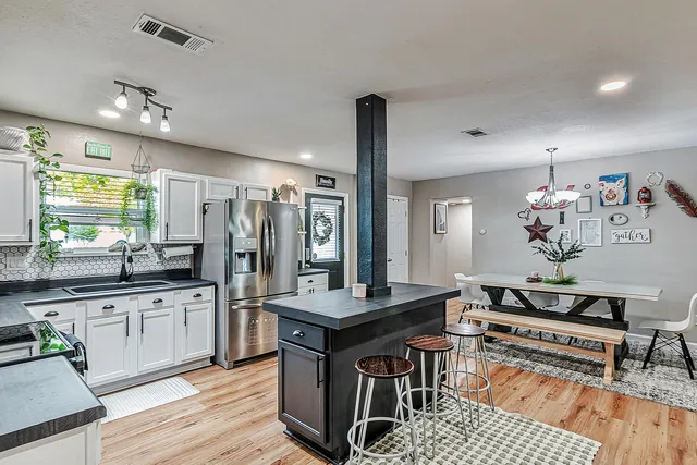 a living room with granite countertop kitchen furniture and a wooden floor