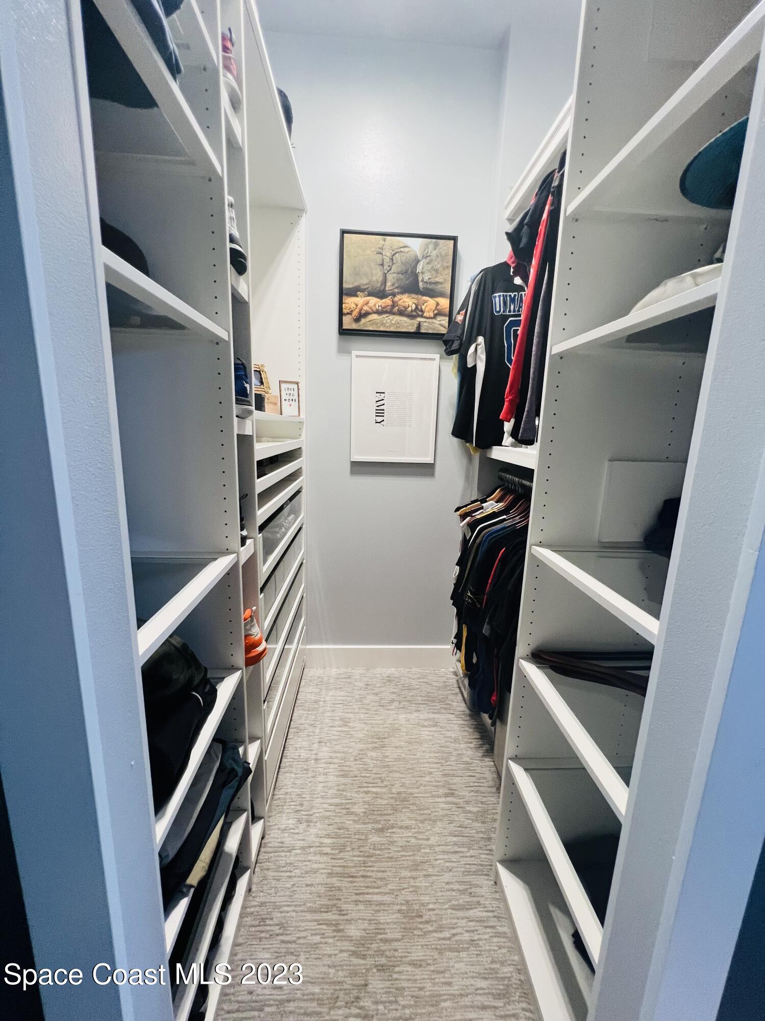 3231 Windsor Estates Drive Melbourne, FL 32940 - Photo 13 of 40 a view of walk in closet with clothes and shoes