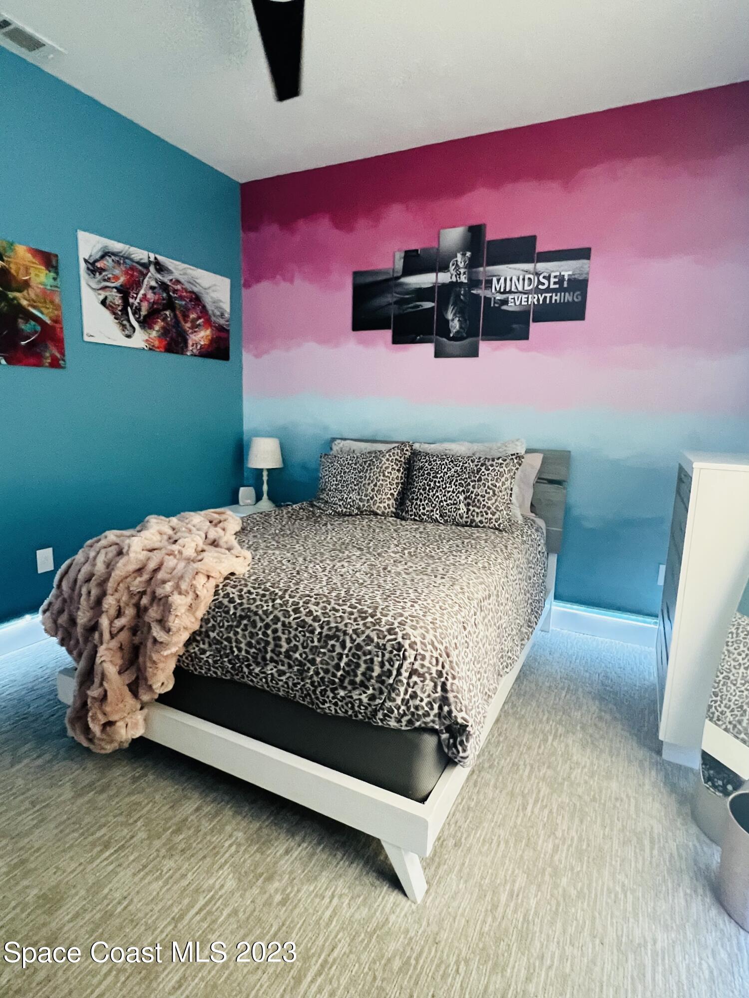 3231 Windsor Estates Drive Melbourne, FL 32940 - Photo 24 of 40 a bedroom with a bed and a dresser