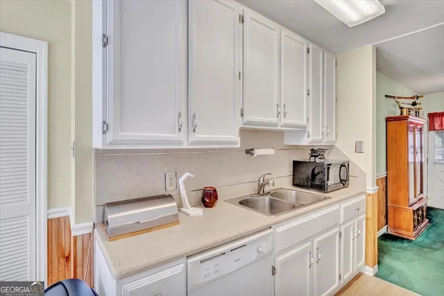a living room with furniture and a dining table