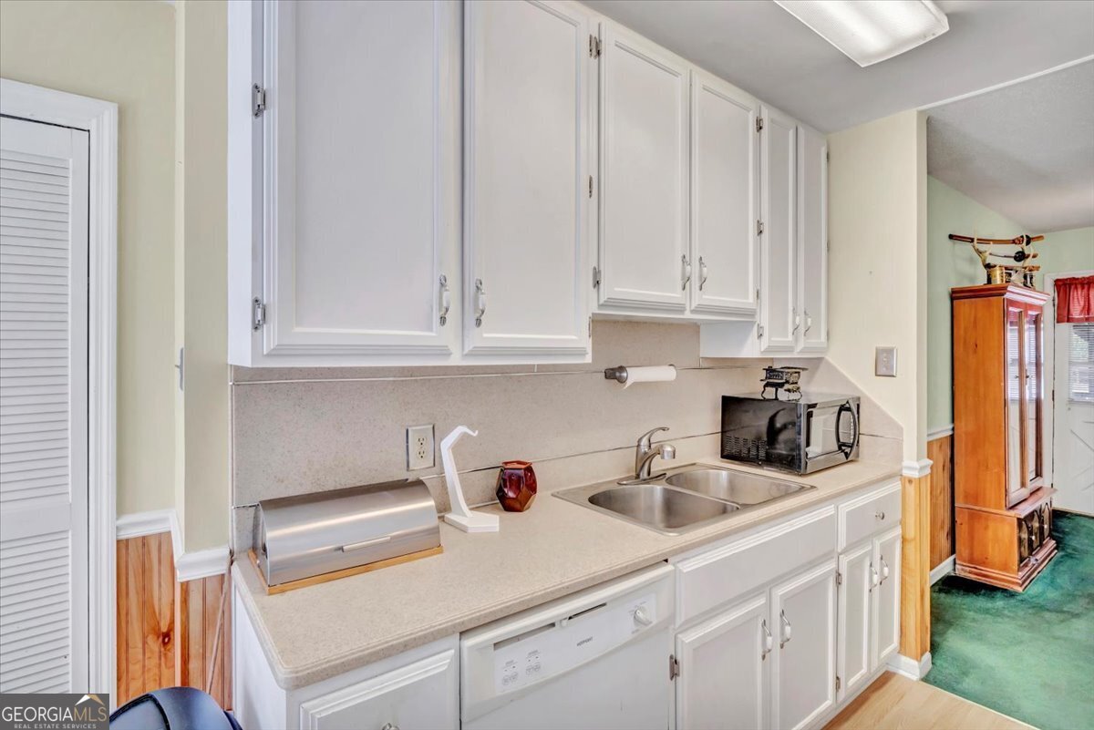 1702 Vada Road Bainbridge, GA 39817 - Photo 19 of 33 a kitchen with white cabinets and sink