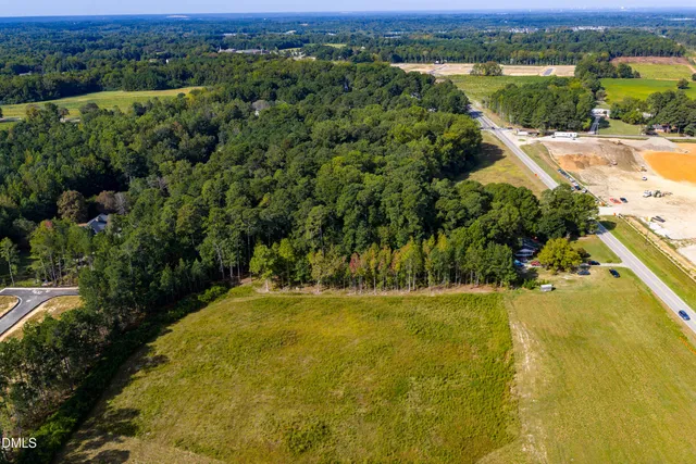 an aerial view of residential houses with outdoor space and river