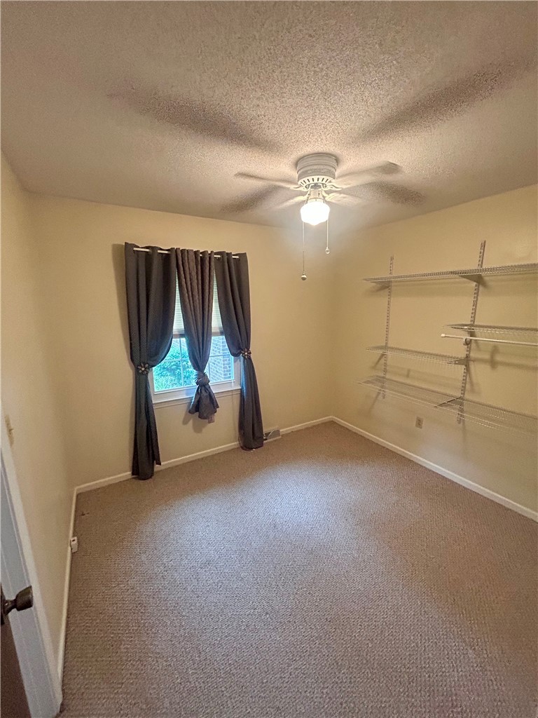 307 Mar-Mac Road Anderson, SC 29626 - Photo 12 of 19 A well-lit bedroom features plush carpeting and convenient shelving.