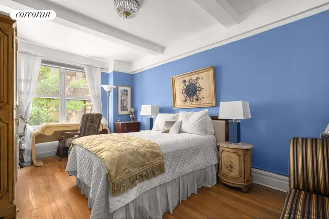 a bedroom with a bed a couch and large window