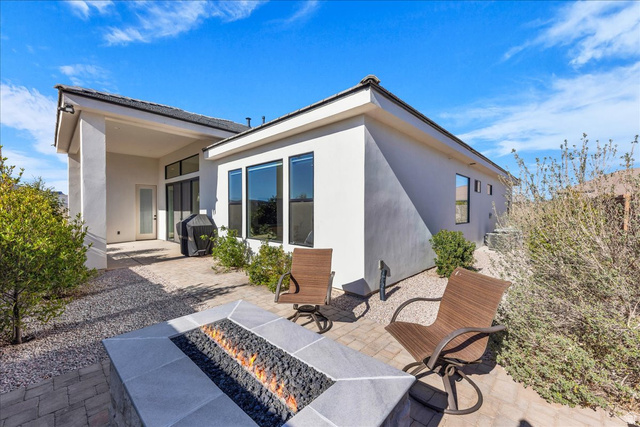 404 North Marsala Way St. George, UT 84770 - Photo 24 of 26 Rear view of house with an outdoor fire pit, a patio area, and stucco siding