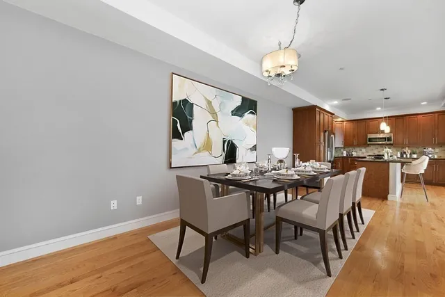 a view of a dining room with furniture and wooden floor