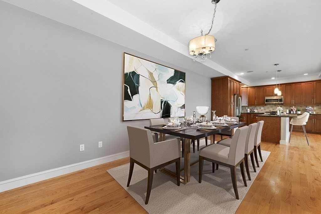 350 West 2nd Street, Unit 9 Boston, MA 02127 - Photo 11 of 42 a view of a dining room with furniture and wooden floor