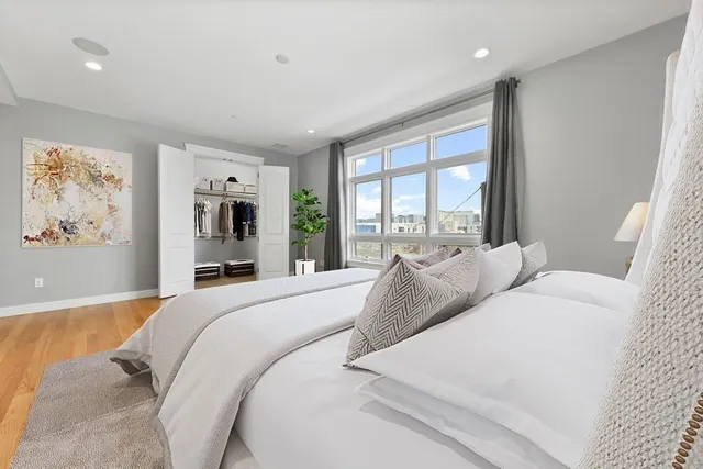 a bedroom with a large bed and a large window