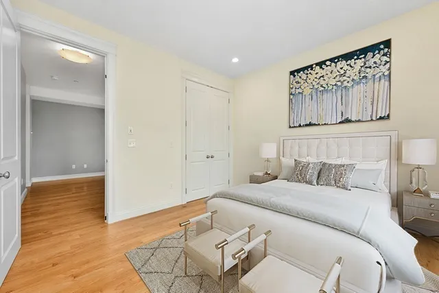 a bedroom with a bed and a painting on the wall