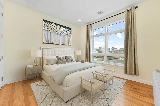 a bedroom with a large bed and a window