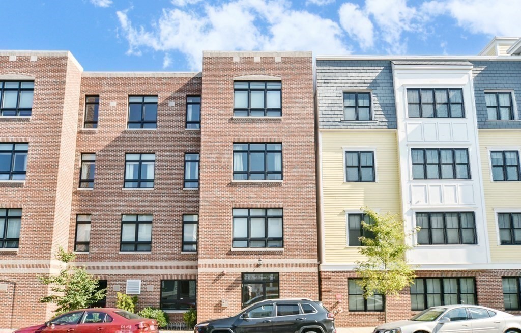 350 West 2nd Street, Unit 9 Boston, MA 02127 - Photo 28 of 42 a front view of a residential apartment building with a yard
